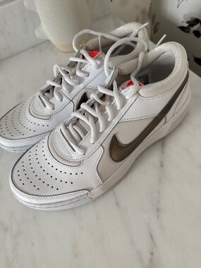 Nike women’s White tennis/pickleball Sneakers with Metallic Bronze Swoosh